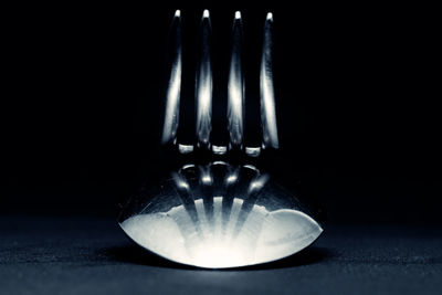 Close-up of illuminated lamp against black background