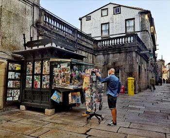 Full length rear view of man standing at market