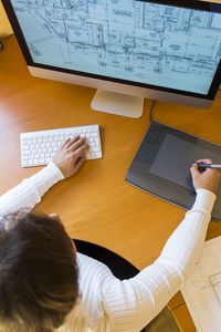 High angle view of architect working on table