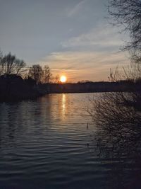 Scenic view of lake against sky during sunset