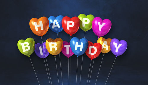 Close-up of multi colored balloons against black background