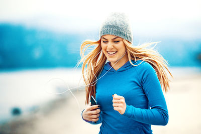 Young woman using smart phone outdoors