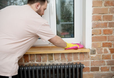 Man working on window