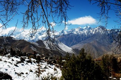 Scenic view of snow covered mountains against sky