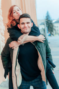 Portrait of young couple standing outdoors