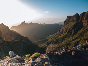 Rear view of man standing on mountain