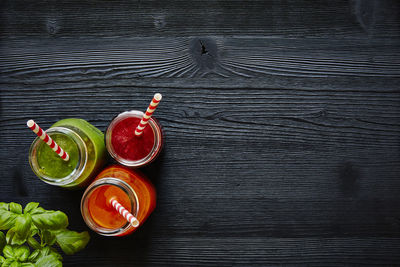 Close-up of smoothie in jars with herb on table