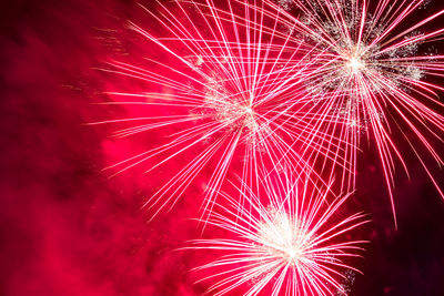 Low angle view of firework display at night