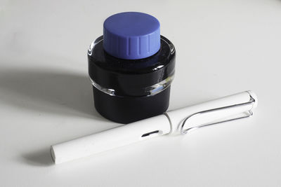 High angle view of glasses on table against white background