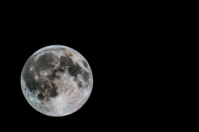 Low angle view of moon against clear sky at night