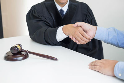 Close-up of man and woman sitting on table