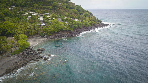 High angle view of sea and trees against sky