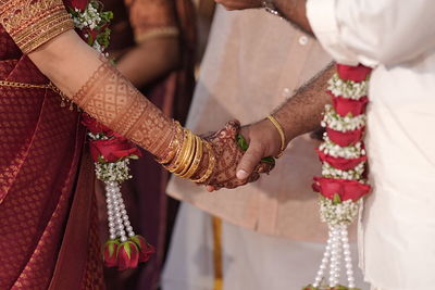 Midsection of bride with henna tattoo