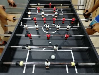 High angle view of friends playing foosball