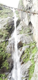 Scenic view of waterfall against sky