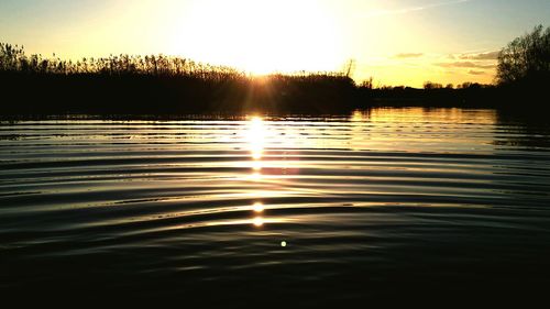Scenic view of lake at sunset