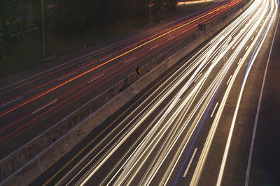 High angle view of light trails on highway at night