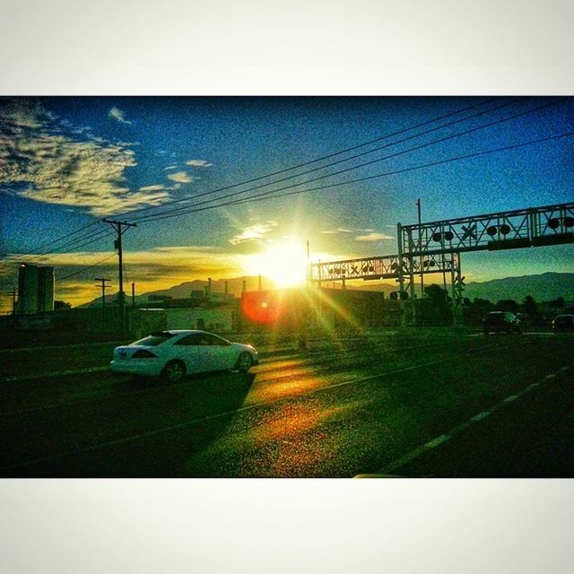 sun, transfer print, transportation, sunset, sunbeam, sunlight, lens flare, car, auto post production filter, land vehicle, sky, mode of transport, road, silhouette, nature, street, bright, electricity pylon, outdoors, sunny