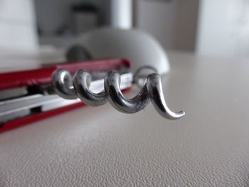 Close-up of corkscrew on table