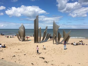 People on beach against sky