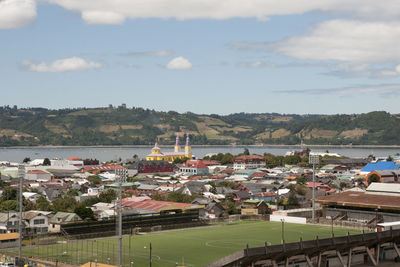 High angle view of buildings in town against sky