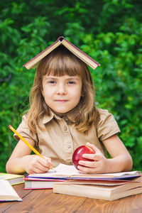 Portrait of young woman reading book