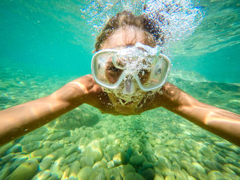 Portrait of boy swimming in sea