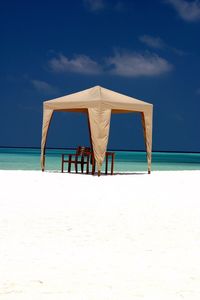 Lifeguard hut on beach against sky