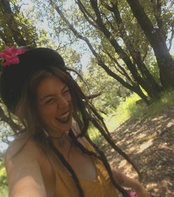 Portrait of smiling young woman in forest