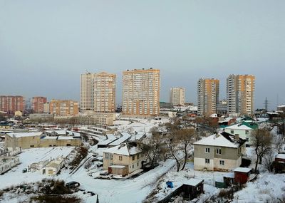 High angle view of buildings against clear sky during winter