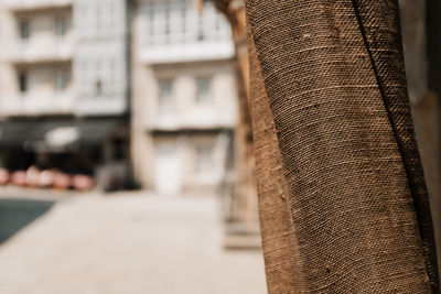 Close-up of fabric against buildings