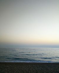 Scenic view of sea against clear sky during sunset