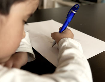 Close-up of human hand holding paper