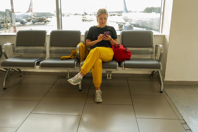 Side view of woman sitting in train