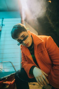 Portrait of young man sitting outdoors