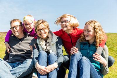 Happy family sitting on field