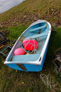 High angle view of red boat moored on field