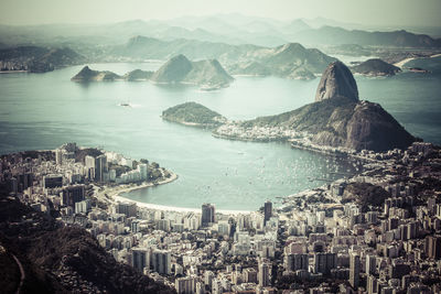 High angle view of buildings by sea