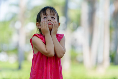 Portrait of cute girl standing outdoors