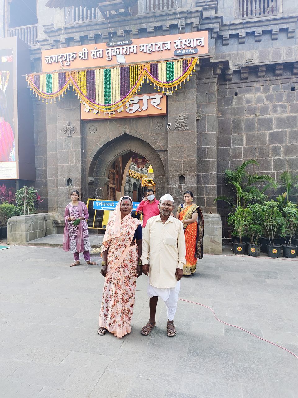 architecture, group of people, full length, building exterior, built structure, city, women, men, adult, traditional clothing, building, child, text, street, tourism, clothing, childhood, religion, walking, communication, travel destinations, day, outdoors, crowd