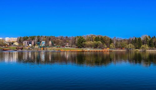 Scenic view of lake against clear blue sky