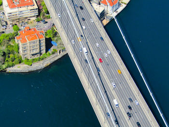 High angle view of cars moving on bridge over sea during sunny day