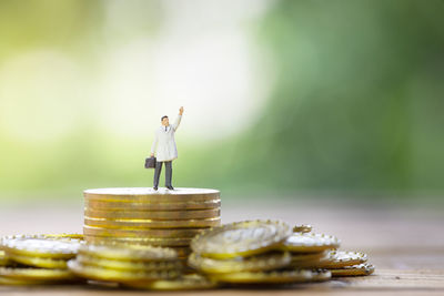 Figurine on stacked golden coins