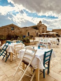 Empty chairs and tables at beach