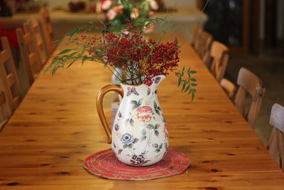 Close-up of potted plant on table. flower vase arrange on top of wood table winter style.