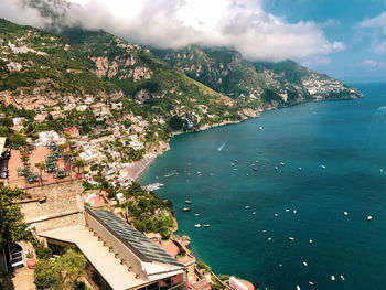 High angle view of buildings by sea against sky