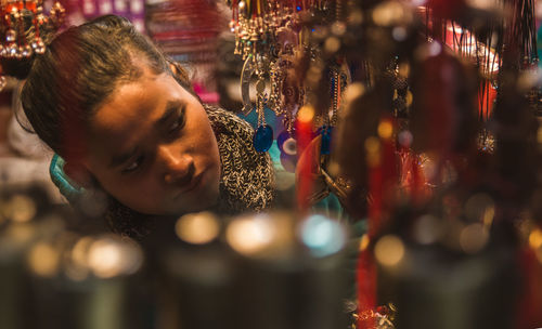 Portrait of woman looking at illuminated christmas lights