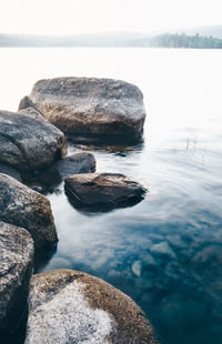 Rocks on beach against sky