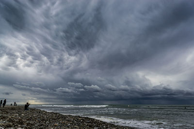 Scenic view of sea against cloudy sky