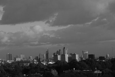 View of cityscape against cloudy sky